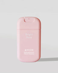A pink HAAN Bright Rose hydroalcoholic hand cleanser bottle, shown on a light gray background with a soft shadow.