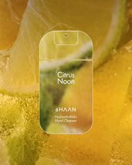 HAAN Citrus Noon hand cleanser packaging with a citrus background