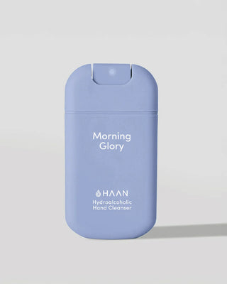 A light blue squeeze bottle of HAAN Morning Glory Hydroalcoholic Hand Cleanser, centered on a light gray background.