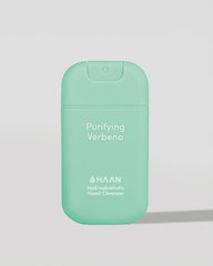 Green hand sanitizer bottle with 'HAAN' branding on a light gray background