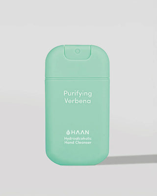 Green hand sanitizer bottle with 'HAAN' branding on a light gray background