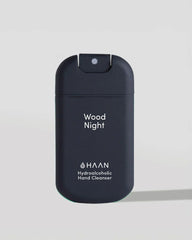 HAAN Wood Night Hydroalcoholic Hand Cleanser in a dark navy blue pump bottle, shown on a light gray background.