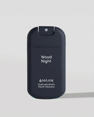 HAAN Wood Night Hydroalcoholic Hand Cleanser in a dark navy blue pump bottle, shown on a light gray background.